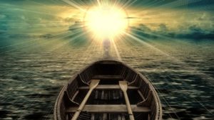 boat with oars facing bright sun photo