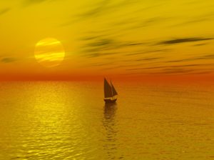 yellow orange sunset with sailboat facing horizon image