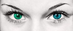 a picture of a woman's eyes, one blue one green photo