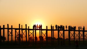 people on bridge dock at sunset image