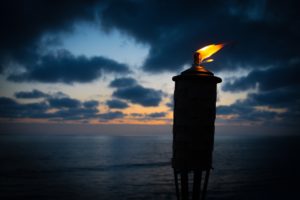 torch lit with dark sunset at the beach image