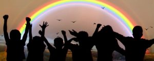 children cheering rainbow at the beach image