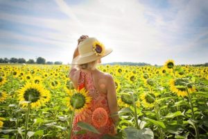 December 2021 Energy Update - Woman In Sunflower Field - Frequencywriter.com